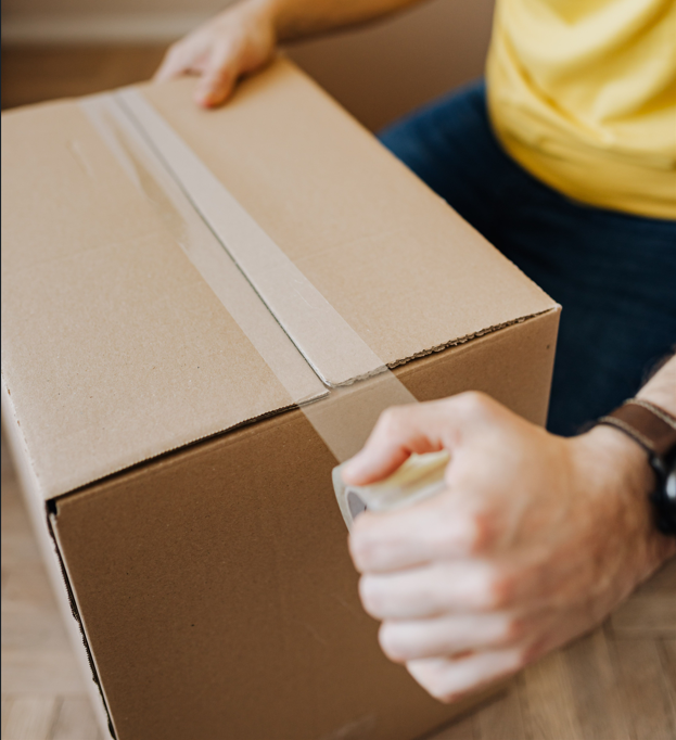 Sealing a cardboard shipping carton with packing tape